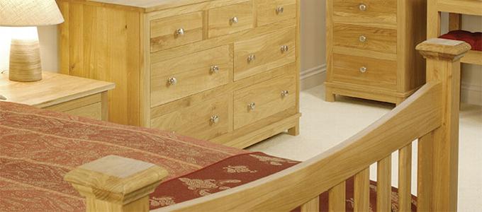 Handmade solid oak bedroom furniture including bed, side tables and chest of drawers